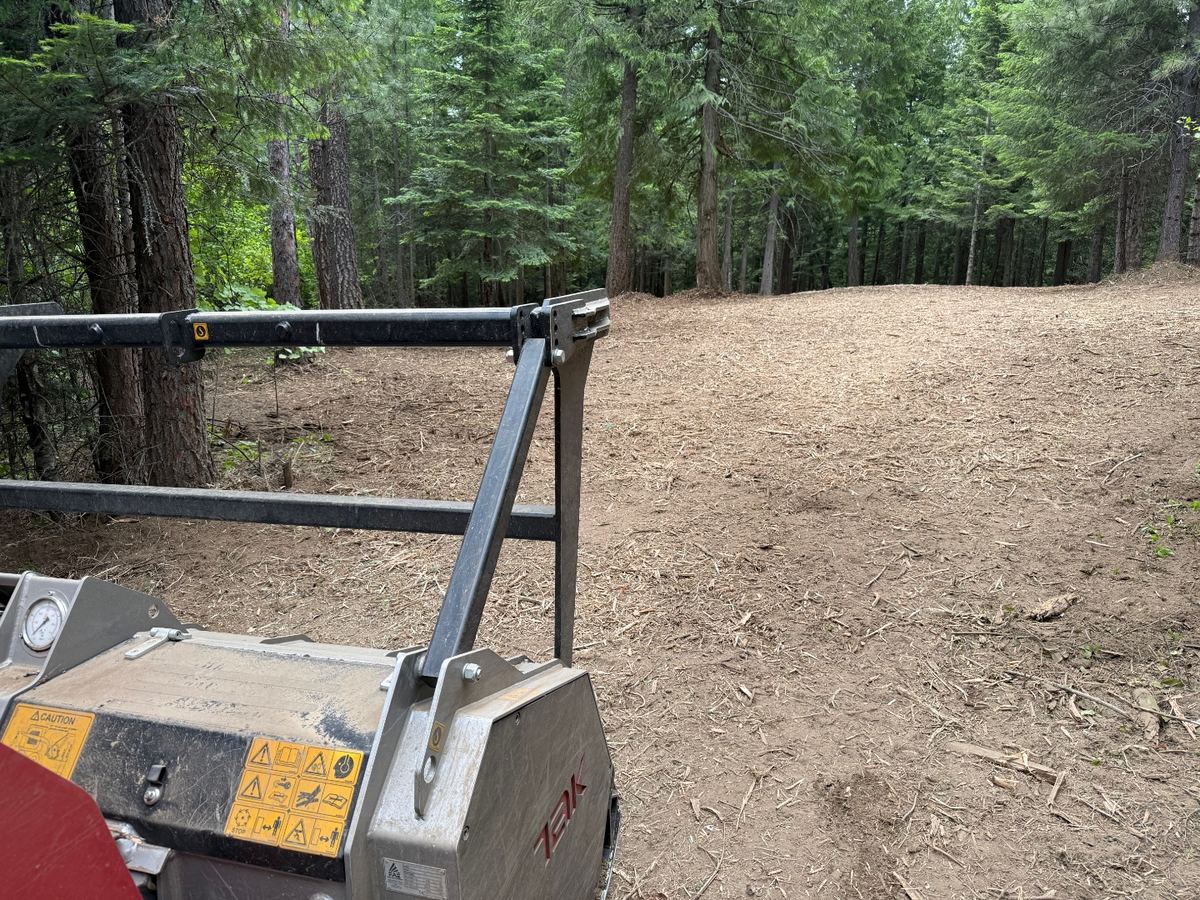Premier Land Service forestry mulcher head clearing brush in North Idaho