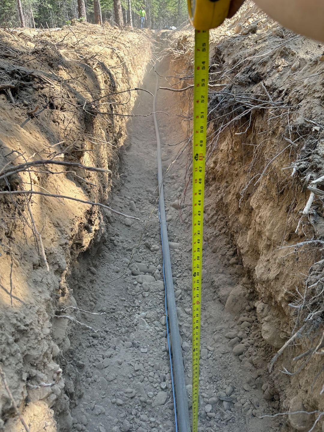 Waterline trench and frost-free hydrant installation completed at a Spirit Lake, Idaho property — Premier Land Service utility excavation in Kootenai County