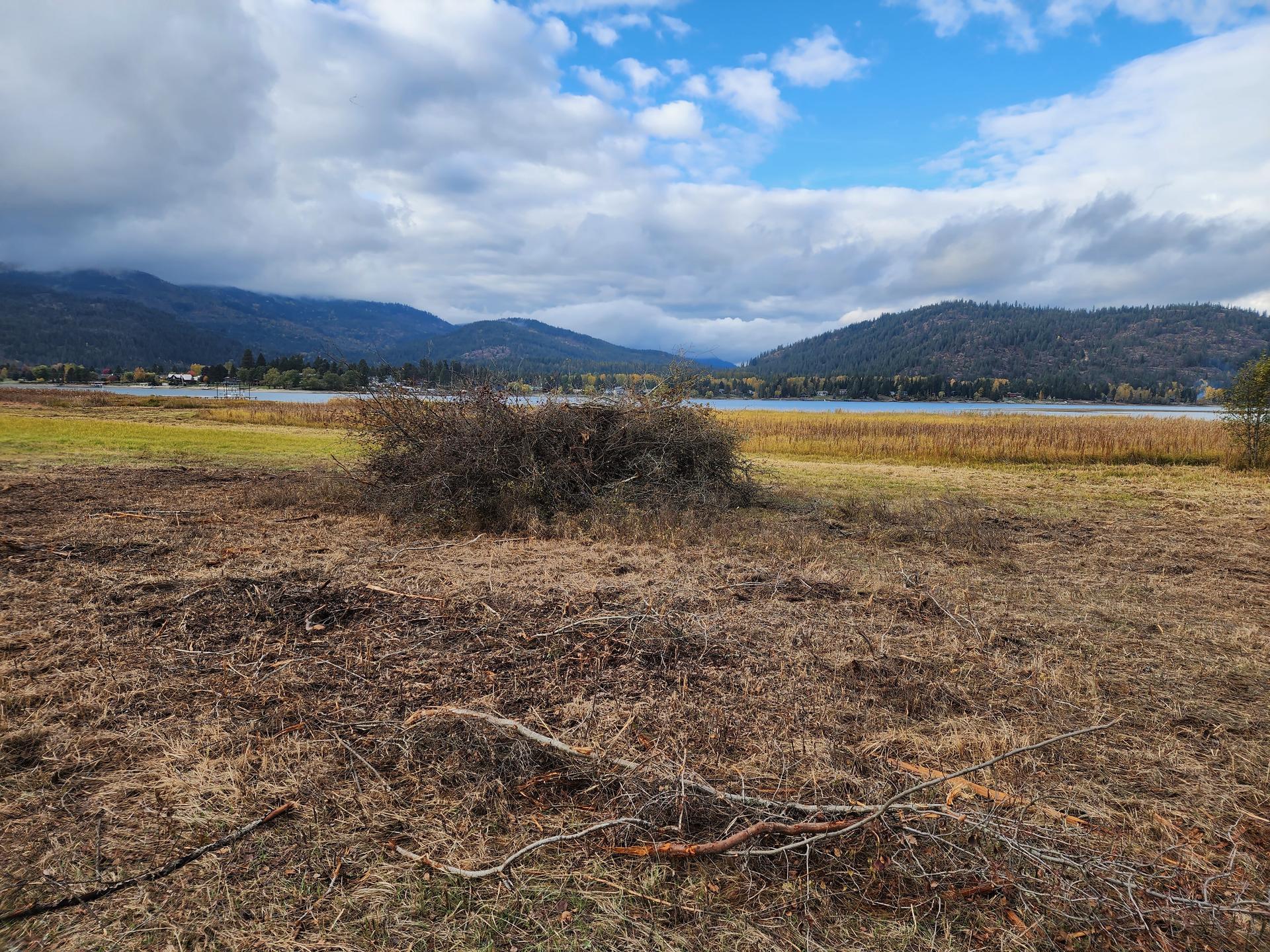 Large cleared property parcel with Pend Oreille lake visible in distance