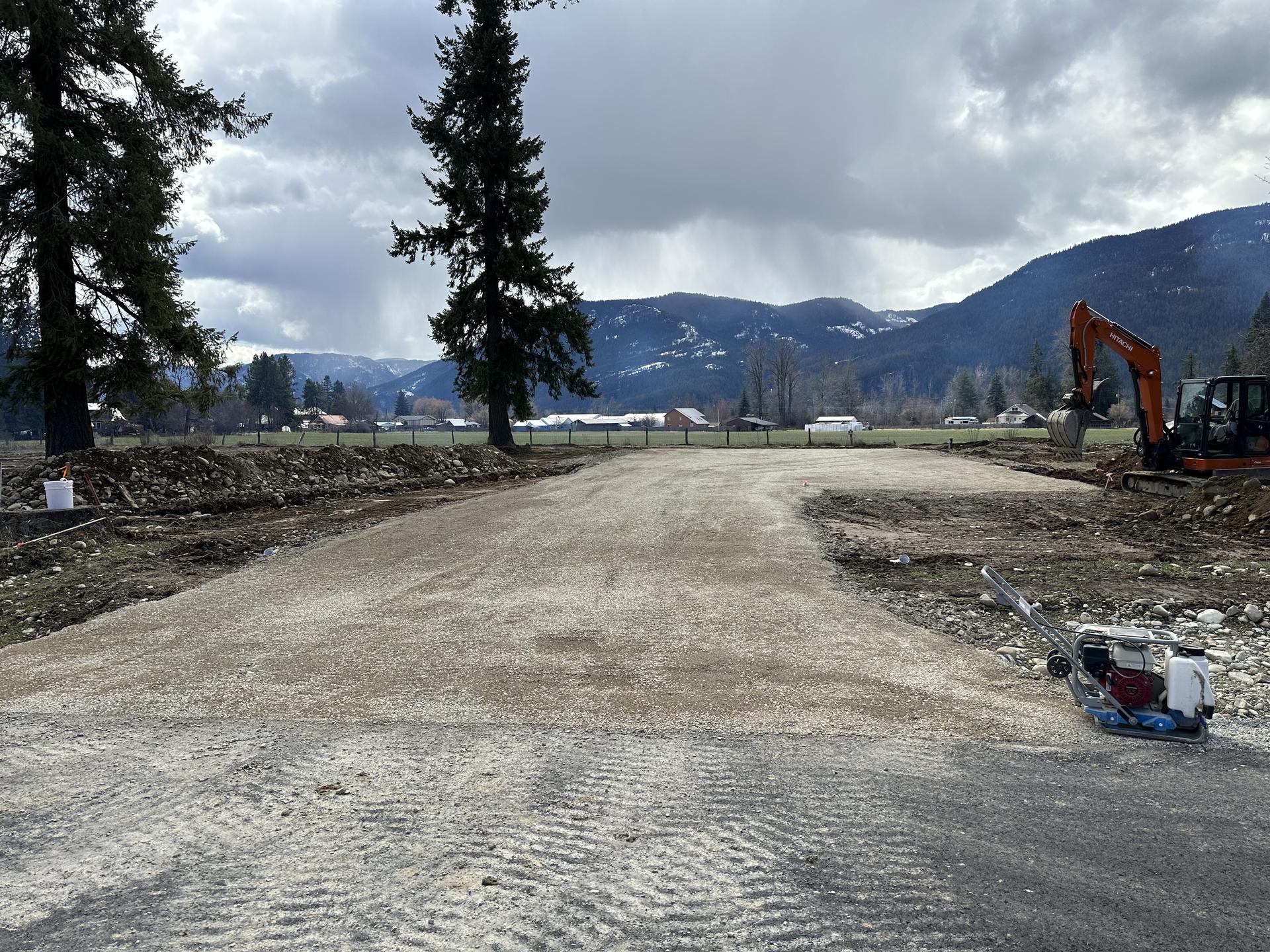 Premier Land Service gravel driveway compaction and finish grading with mountains