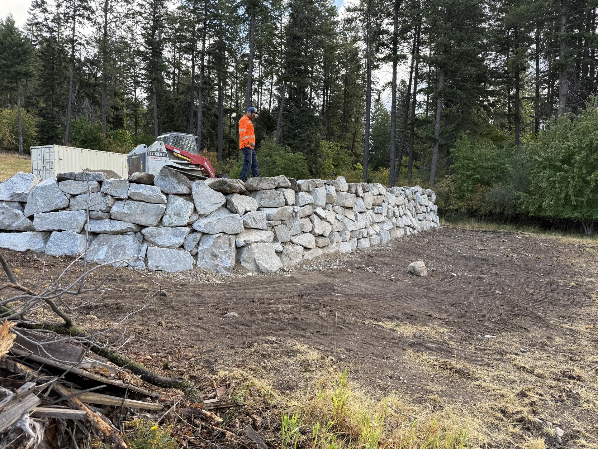 Premier Land Service boulder retaining wall on lakefront property with Pend Oreille view